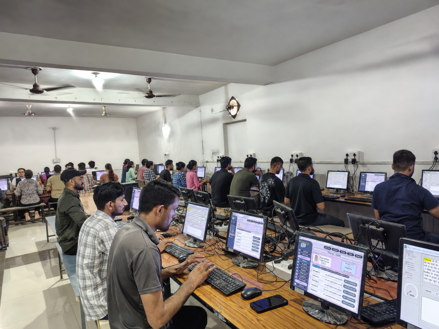 Students doing individual computer practice with Roma Skill
