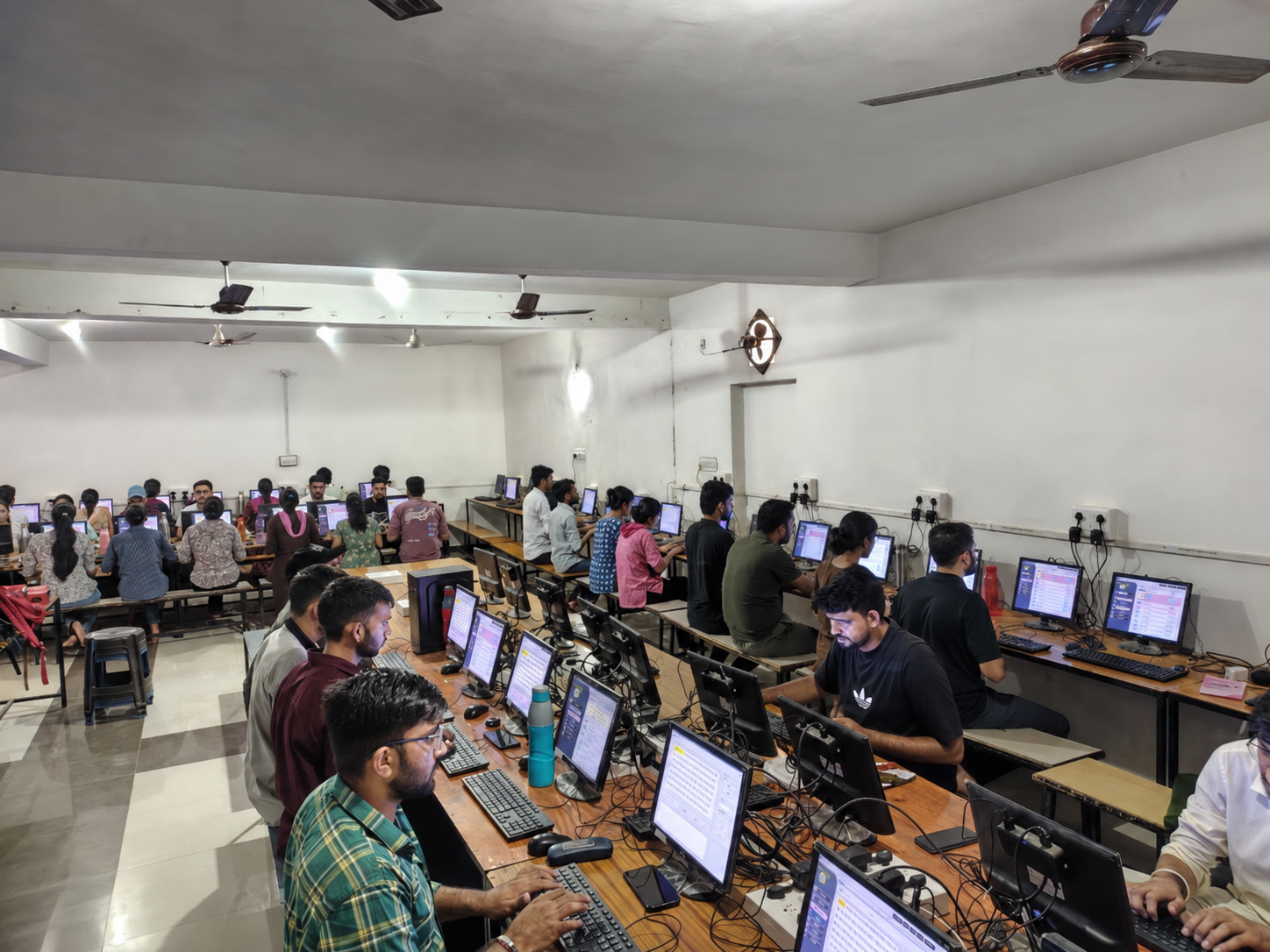 Wide view of students in the Roma Skill computer lab